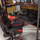 close up image of the gaming desk and gaming chair setup with curved screen monitors and accessories